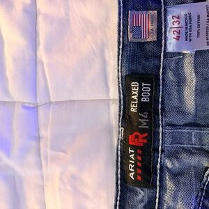 Ariat Men's Indigo Relaxed Flame Resistant Jeans. Slight stain on right seam.